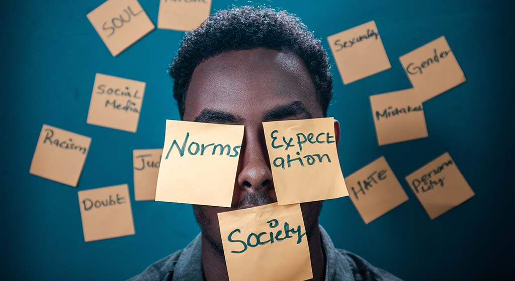 Man covered in sticky notes. Perfectionism isn't rational. You are not allowed to make mistakes, but that is false. Overcoming perfectionism in Detroit, MI is possible. If you need support begin therapy for anxiety and perfectionism in detroit, mi today. Call now!
