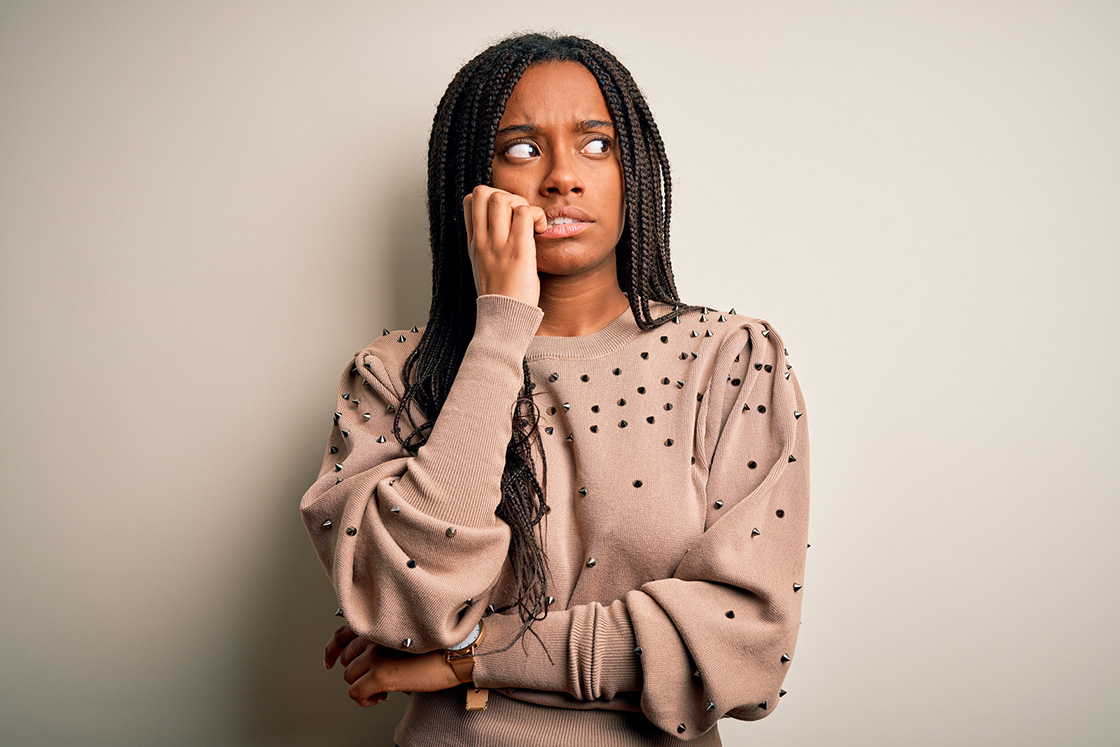Black woman in beige sweater bitting nails and looking worried. When you're going through changes life is stressful. Whether good or bad, therapy for life transitions in Detroit, MI can help you breathe. Whether you need caregiver support, support for mom burnout, or relationship therapy for singles. We are here to help!