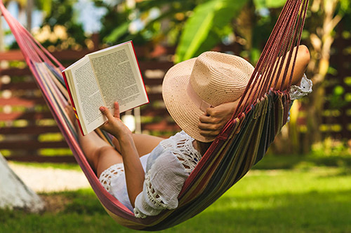 Woman reading book outside on hammock. Ready for a transition? Let's talk about these self-care tips in Detroit, MI or find some skills that work for you. Talk with an online therapy who works with moms, high achievers, professionals, and more. Call now and begin to move forward via online therapy today!