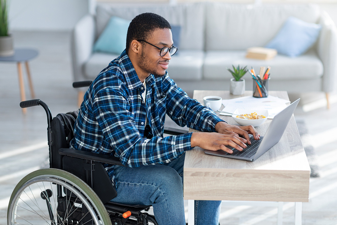 Man in wheel chair on laptop. If you're struggling to overcome the trauma of an injury or are grieving, our EMDR therapists are here to help. Find EMDR therapy near me, and begin to find healing today. Try EMDR therapy in Detroit, MI for support!