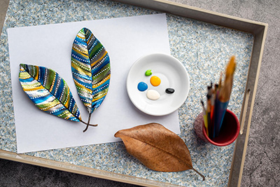 Painted leaves near paper and brushes. Find the support you need with these self-care tips in Detroit, MI. Whether you're in need of anxiety treatment, depression treatment, PTSD treatment and trauma therapy, or another online therapy service in Michigan, our therapists can help. Call now and begin therapy!