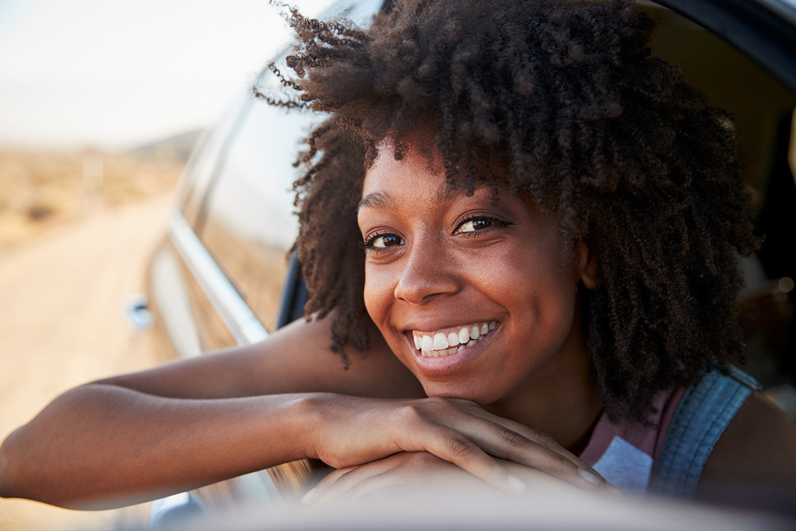 Black women with head out window of car smiling. Although life changes are stressful at times, getting the support you need in therapy for life transitions in detroit, MI can put your experience in perspective. Get started with relationship therapy for singles, caregiver support, therapy for moms, and more today!