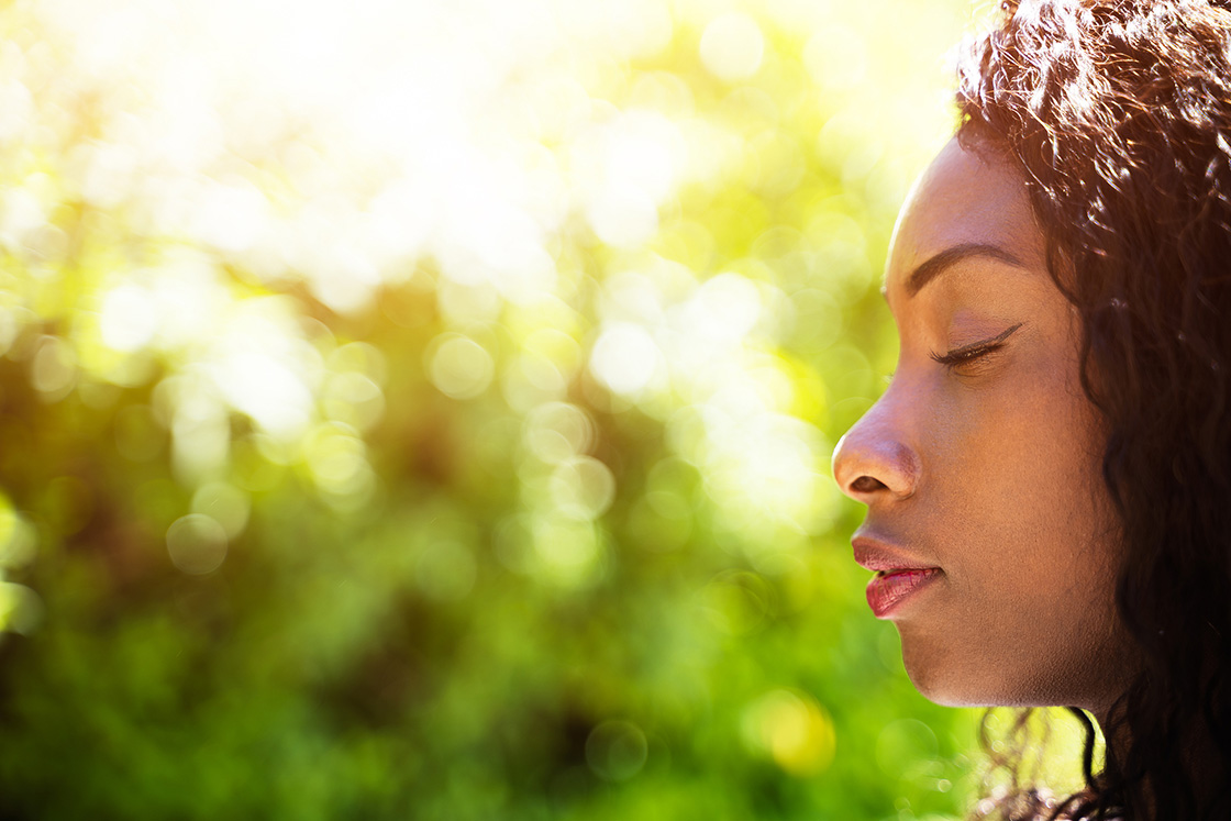 Close up of black woman outside breathing deeply. When you're struggling with being in the present moment, ACT therapy can help you feel grounded. Begin in-person or online therapy in Michigan for Acceptance and Commitment in Detroit, MI. Call now!
